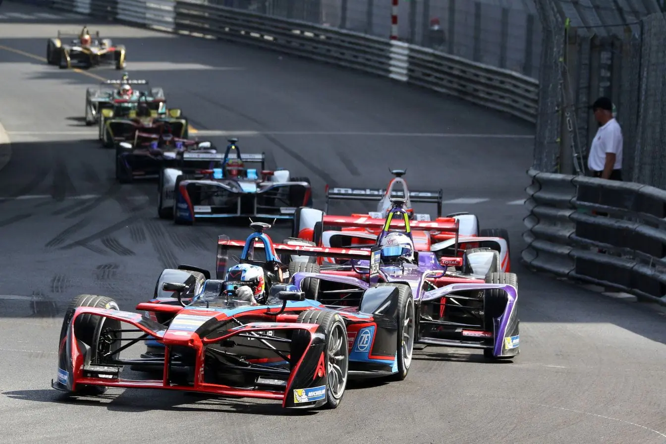 Voitures de course électriques en compétition sur circuit urbain, reflet des grandes étapes de l’évolution de la Formule 1.