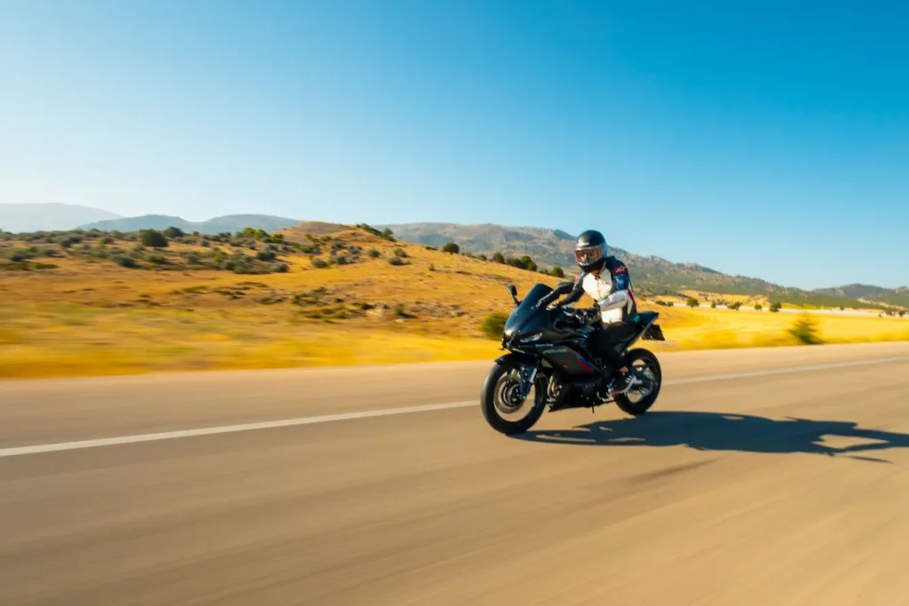 Gros plan sur moto noire filant sur route, reflet de passer du permis A2 au permis A sans examen.